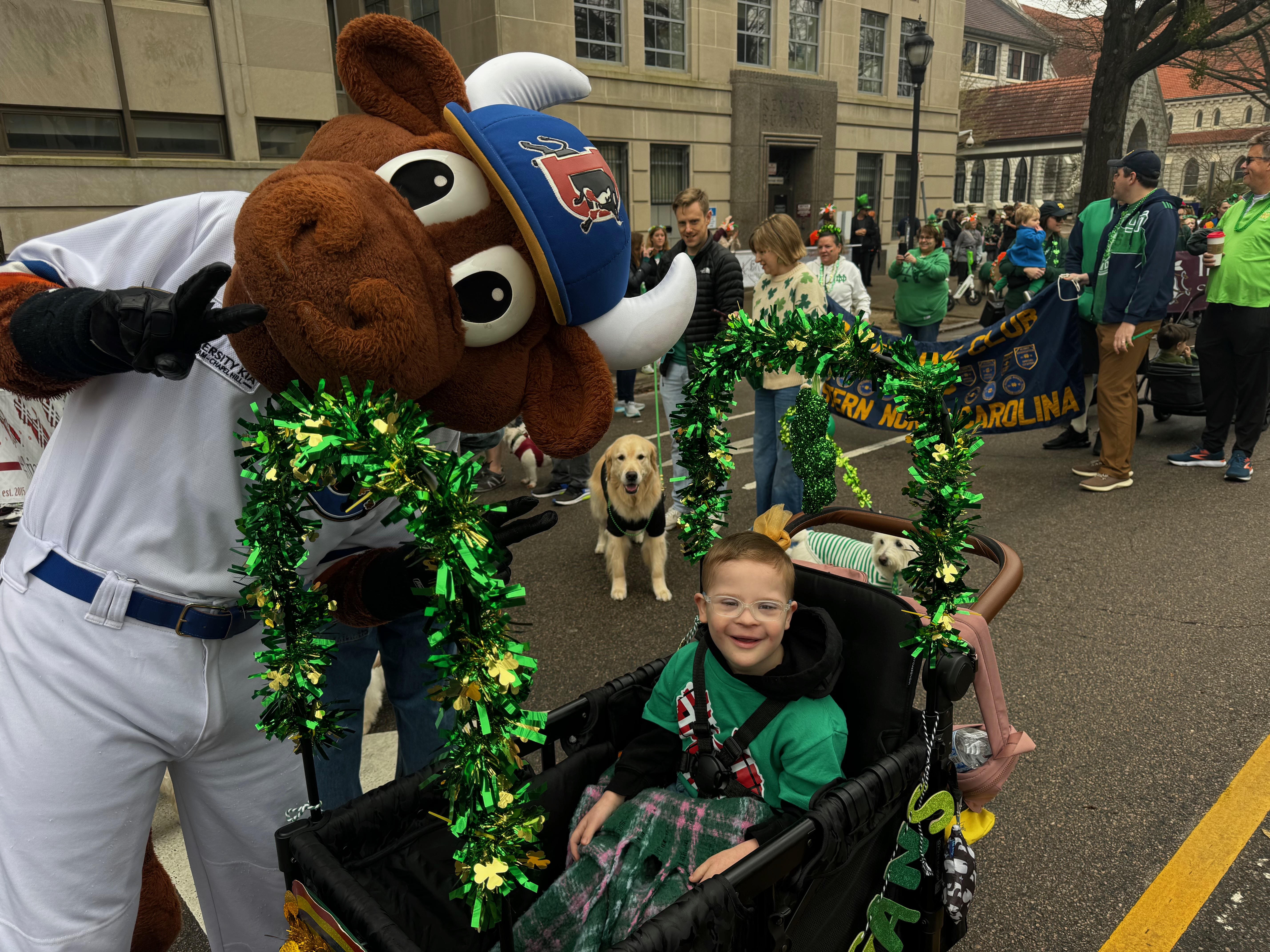 Charlie at a parade with a baseball mascot