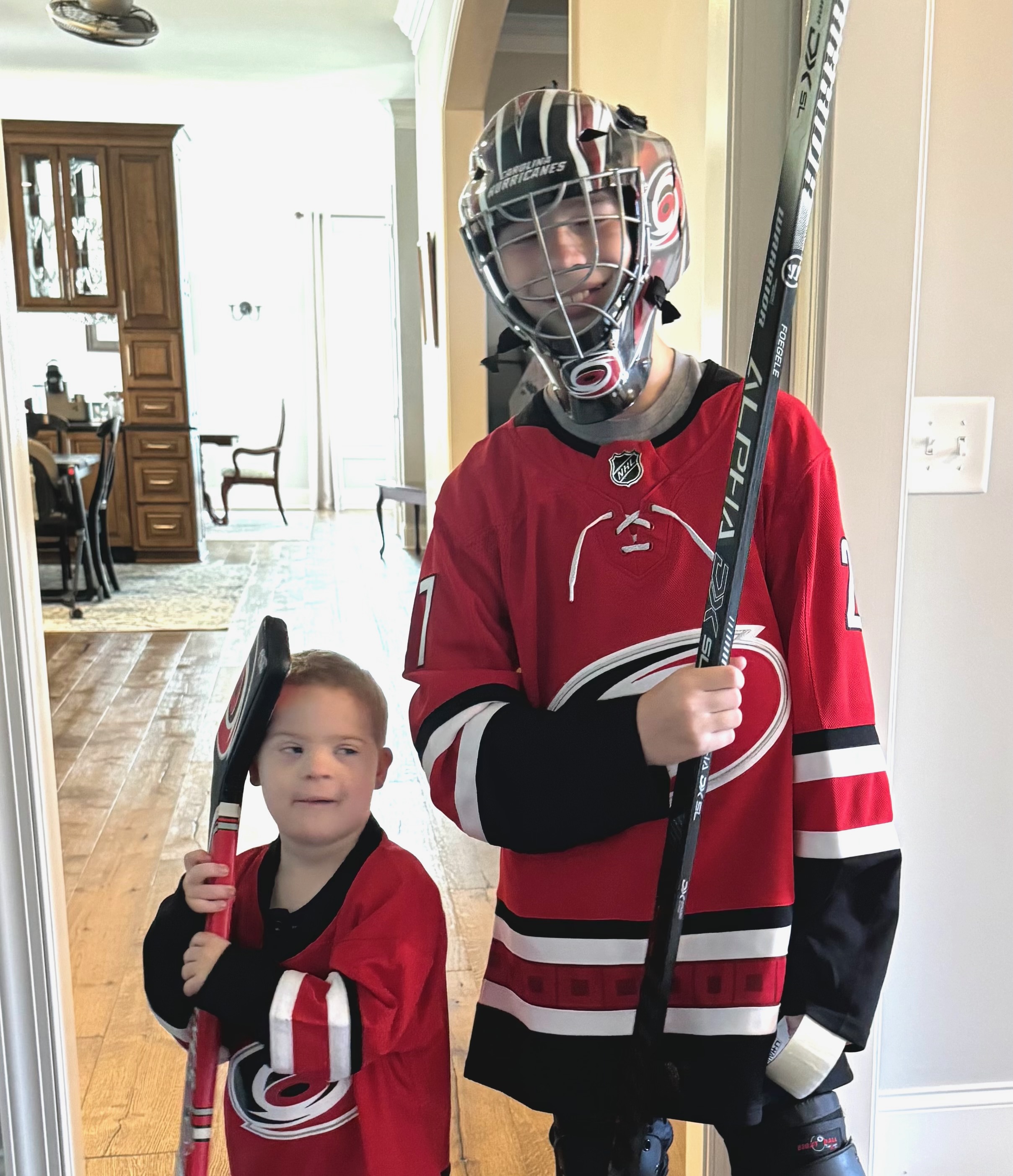 Charlie and Andy in matching Hurricanes hockey jerseys