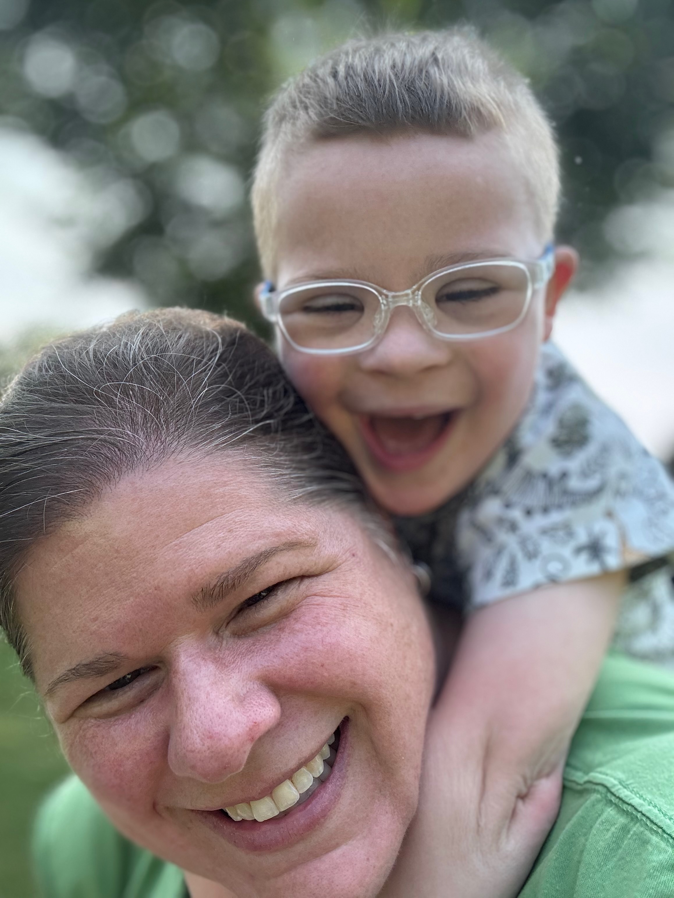 Charlie laughing on Kristy's back
