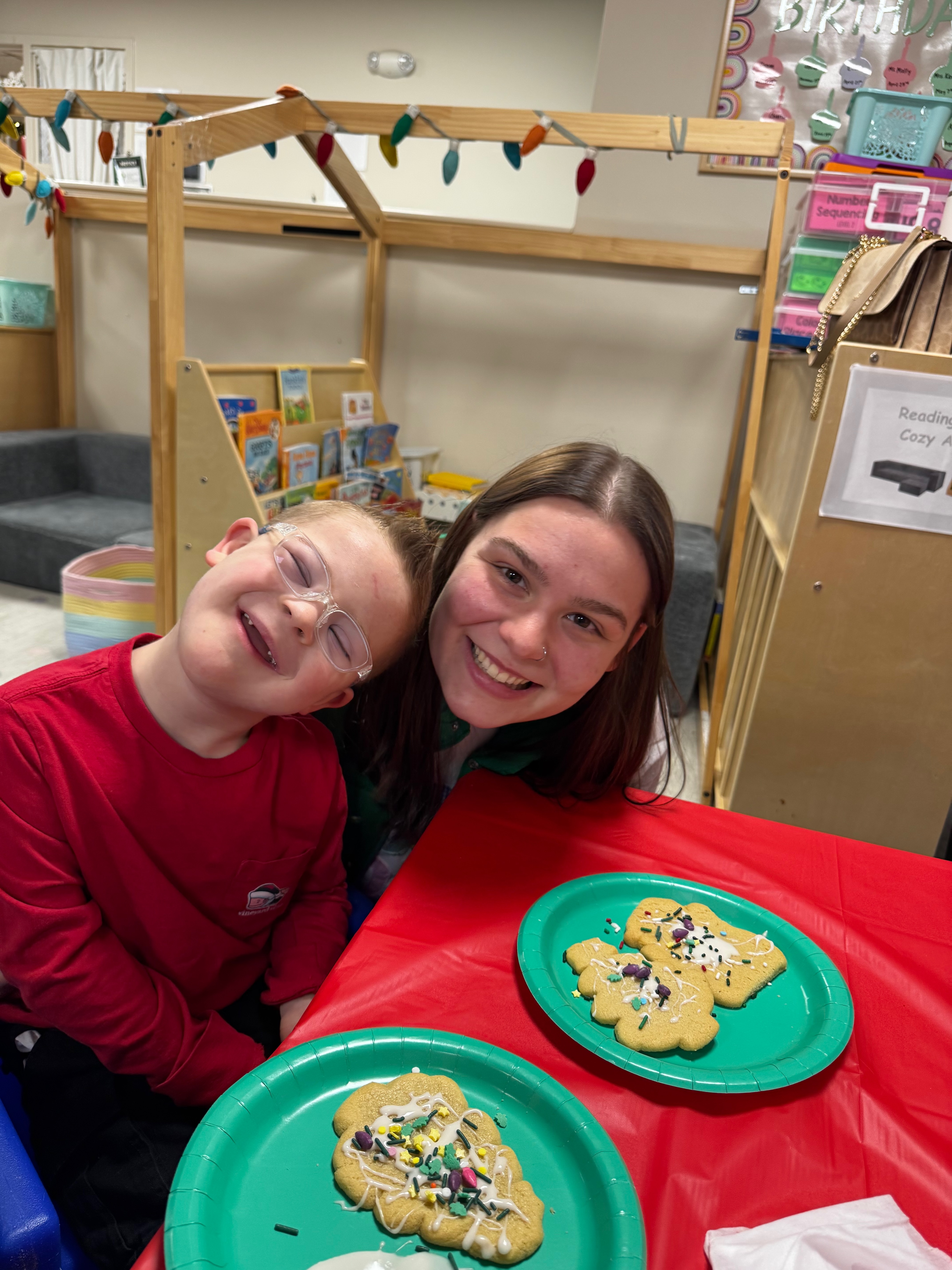 Charlie decorating cookies at school with a friend